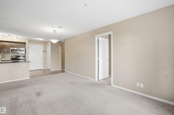 Kitchen with dark wood-finish cabinetry, stainless steel appliances, and a breakfast bar - 