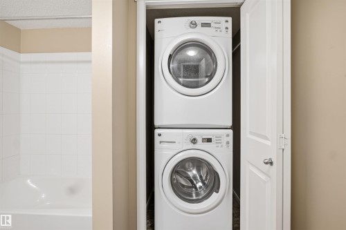 Built-in stacked washer and dryer appliances within a dedicated closet - #225 1510 Watt Dr Sw, Edmonton, AB 