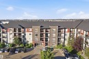 Multi-story residential building with brick and siding facade, private balconies, and an onsite parking area - #225 1510 Watt Dr Sw, Edmonton, AB 