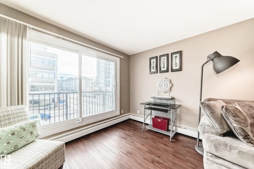 Expansive sliding glass doors, hardwood-finish flooring, and neutral wall tones - #302 10606 123 St Nw, Edmonton, AB 