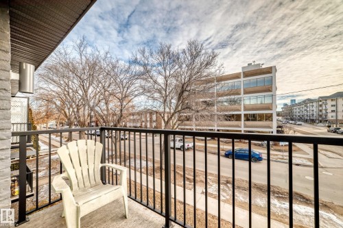 Private balcony with dark metal railings, concrete flooring, and a brick exterior wall - #302 10606 123 St Nw, Edmonton, AB 