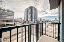 Exterior balcony featuring a concrete floor and black metal railings - 