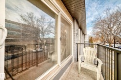 Outdoor balcony with a sliding glass door and metal railings - 