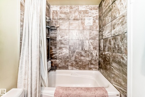 Tub and shower combination with stone-look tile surround - #302 10606 123 St Nw, Edmonton, AB 