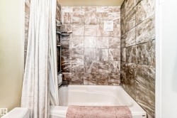 Tub and shower combination with stone-look tile surround - 
