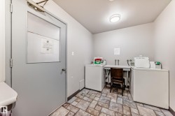 Laundry room featuring two washing machines, a utility sink, and tiled flooring - 