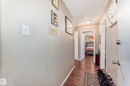 Wood-finish flooring throughout the hallway - #302 10606 123 St Nw, Edmonton, AB 