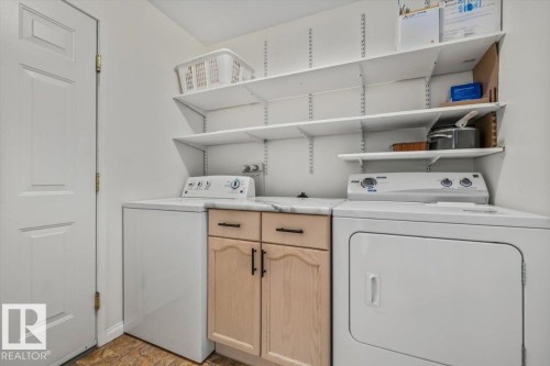White shelving system, wood-finish cabinetry, and a light-toned countertop - #92 13320 124 St Nw, Edmonton, AB 