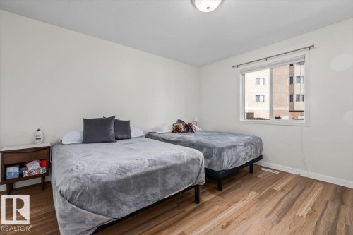 Wood-finish flooring, white walls, and a window providing natural light - #92 13320 124 St Nw, Edmonton, AB 