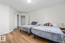 Light wood-finish flooring with white walls and trim, featuring a flush-mount ceiling light - 