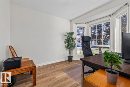 Bay window with multiple panes, wood-finish flooring, and white walls - #92 13320 124 St Nw, Edmonton, AB 