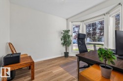 Bay window with multiple panes, wood-finish flooring, and white walls - 