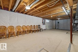Exposed wood ceiling joists and support beams, with a finished floor surface - 