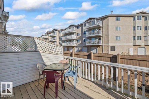 Outdoor wood-plank decking with a white railing and lattice privacy screen - #92 13320 124 St Nw, Edmonton, AB 