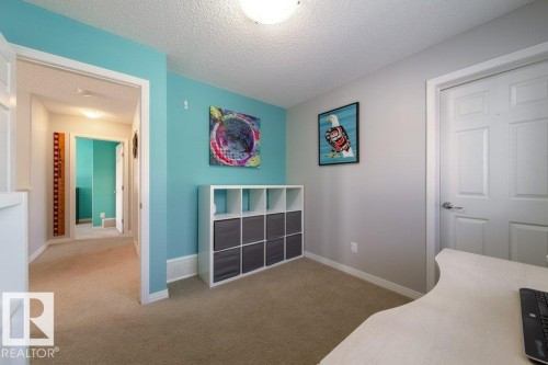 Neutral tone wall paint, textured ceiling, carpet flooring, and white trim - 16120 138 Street Nw, Edmonton, AB 