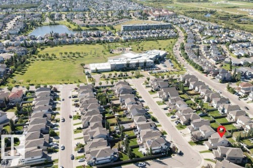 Neighborhood setting featuring established residential streets, a structured community layout, a central green space, and a visible body of water - 16120 138 Street Nw, Edmonton, AB 