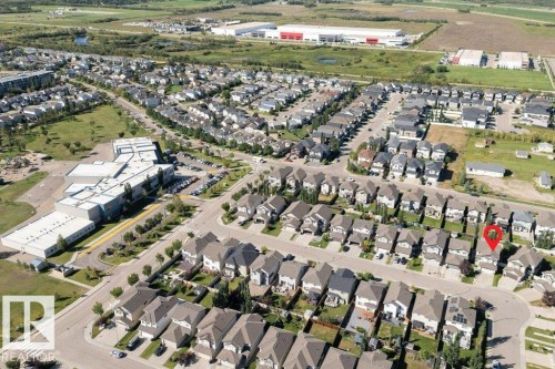Aerial perspective showcasing a residential neighborhood with a large institutional building and surrounding green spaces - 16120 138 Street Nw, Edmonton, AB 