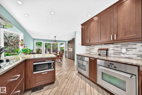 Recessed lighting, wood-finish flooring, wood cabinetry, stone countertops, and stainless steel appliances - 8224 186 Street Nw, Edmonton, AB 