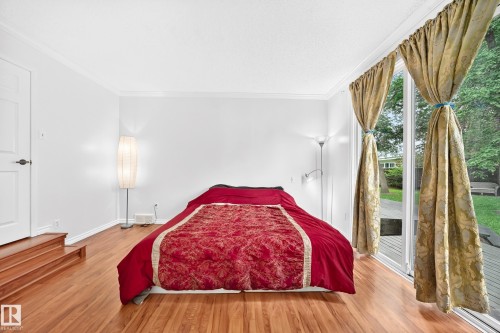 Hardwood-finish flooring, white walls, and crown molding - 8224 186 Street Nw, Edmonton, AB 