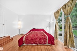 Hardwood-finish flooring, white walls, and crown molding - 