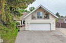 Exterior featuring a two-car garage, upper-level balcony, and light-colored siding - 8224 186 Street Nw, Edmonton, AB 