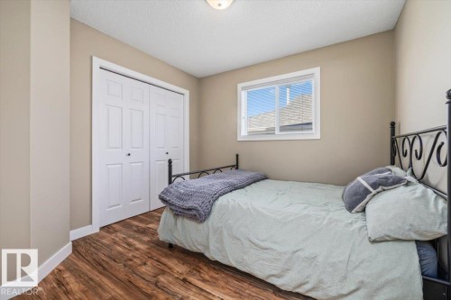 Wood-finish flooring, neutral wall paint, and white trim throughout - 40 Hampton Place, Stony Plain, AB 