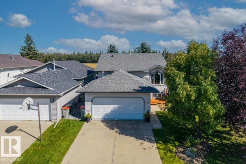 Attached garage with a paved driveway - 40 Hampton Place, Stony Plain, AB 