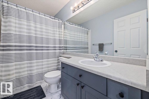 Vanity with an integrated sink, laminate countertop, and lower cabinetry - 40 Hampton Place, Stony Plain, AB 