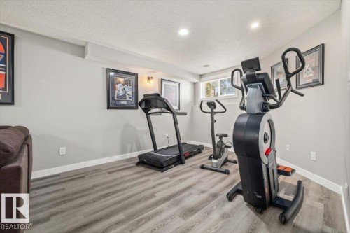 Recessed lighting, wood-finish flooring, white trim, and a window with natural light - 40 Hampton Place, Stony Plain, AB 