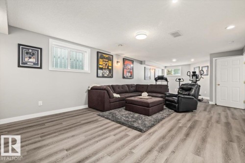 Recessed lighting and a flush mount light fixture illuminate the space - 40 Hampton Place, Stony Plain, AB 