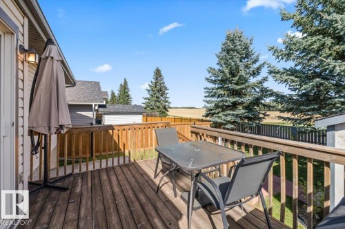 Wood deck with a wooden railing and an exterior light fixture - 40 Hampton Place, Stony Plain, AB 