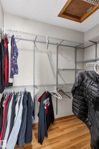 Walk-in closet with wire shelving and wood-finish flooring - 17103 92 Street Nw, Edmonton, AB 