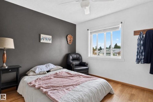 Wood-finish flooring, white ceiling fan, and a window with white trim - 17103 92 Street Nw, Edmonton, AB 