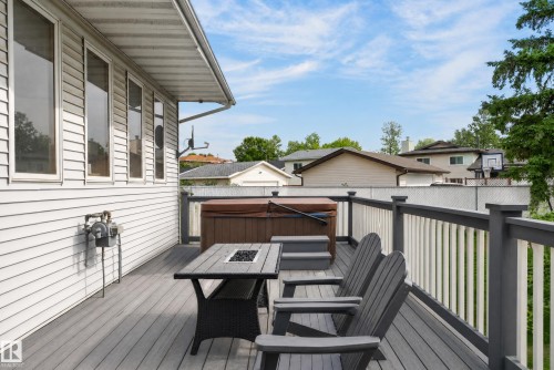 Expansive deck featuring a hot tub, composite decking, and perimeter railing - 17103 92 Street Nw, Edmonton, AB 