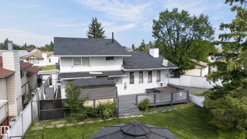 Two-story residence with a dark shingle roof, white siding, and a rear deck - 17103 92 Street Nw, Edmonton, AB 
