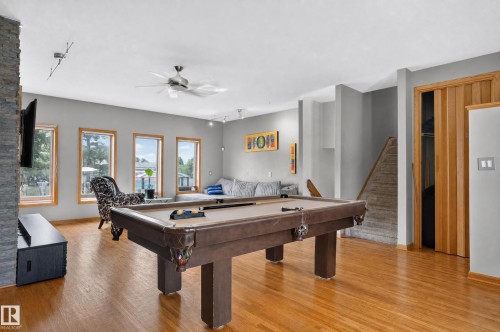 Hardwood-finish flooring, recessed lighting, ceiling fan, natural light from multiple windows, and a built-in window bench - 17103 92 Street Nw, Edmonton, AB 