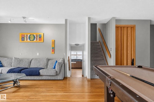 Hardwood-finish flooring, staircase with carpeted treads, wood-finish interior door, recessed lighting - 17103 92 Street Nw, Edmonton, AB 