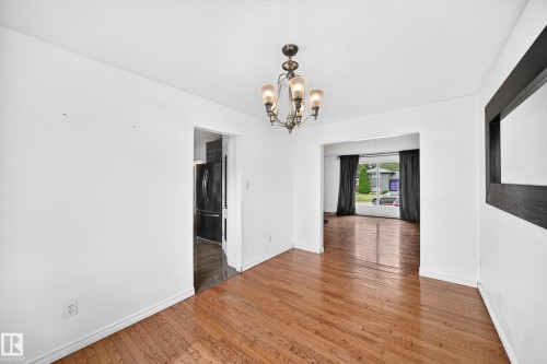 Hardwood-finish flooring, recessed lighting, and a transitional chandelier - 11007 37 Avenue Nw, Edmonton, AB 
