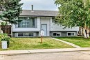 Split-level residence featuring a gray shingle roof, white siding exterior, and a concrete foundation - 11007 37 Avenue Nw, Edmonton, AB 