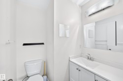 White vanity with cabinet storage, integrated sink, and chrome faucet - 