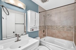 Vanity with an integrated sink, brushed nickel faucet, and mirrored medicine cabinet - 