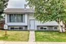 Split-level exterior with white siding and gray trim accents - 11007 37 Avenue Nw, Edmonton, AB 