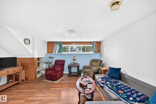 Wood-finish flooring throughout the space - 11007 37 Avenue Nw, Edmonton, AB 