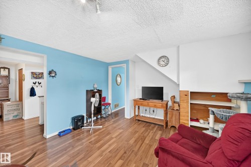 Wood-finish flooring, recessed lighting, built-in shelving, and a prominent staircase - 11007 37 Avenue Nw, Edmonton, AB 