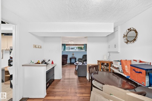 Wood-finish flooring throughout the main level - 11007 37 Avenue Nw, Edmonton, AB 