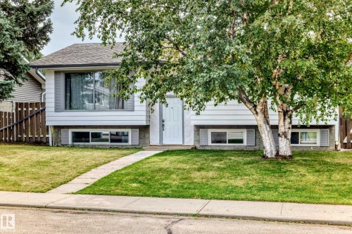 White siding exterior with a gray-shingled roof and front-facing windows - 11007 37 Avenue Nw, Edmonton, AB 