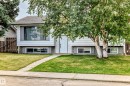 White siding exterior with a gray-shingled roof and front-facing windows - 11007 37 Avenue Nw, Edmonton, AB 