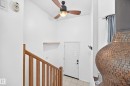 Vaulted ceiling with an attached ceiling fan, wood-finish staircase, and a decorative fireplace - 11007 37 Avenue Nw, Edmonton, AB 