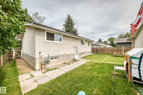 Expansive yard with green lawn, privacy fencing, and mature trees - 11007 37 Avenue Nw, Edmonton, AB 