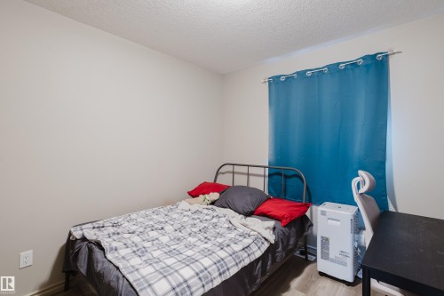 Light-toned walls complement wood-finish flooring - 10334 161 Street Nw, Edmonton, AB 